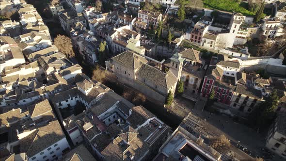 Aerial view of quaint Mudejar church next to Darro river, Granada