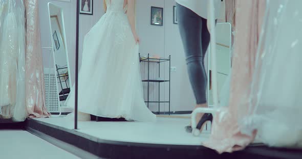 Girls are Trying on a Beautiful Wedding Dress alt
