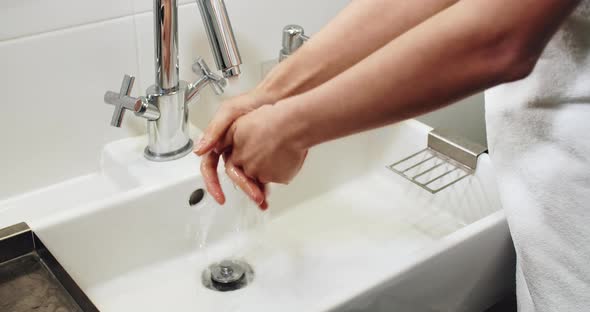 Washing Hands in Washbasin