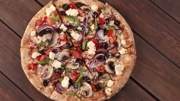 Whole fresh round pizza with chicken meat, vegetables, mushrooms and cheese rotating