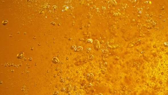 Super Slow Motion Detail Shot of Rippling Beer Bubbles in Glass at 1000Fps alt