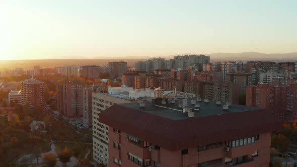 Fly Over Roof of Apartment Building on Large Housing Estate alt