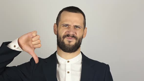 Young Handsome Businessman Shows Thumb Down Expressing His Displeasure
