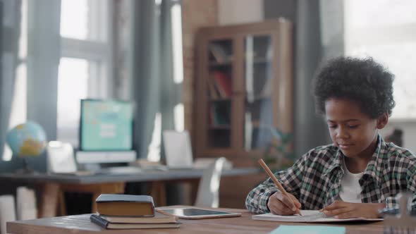 Afro Boy Studying At Home alt