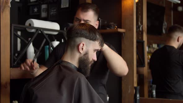 Barber Cutting Hair of Male Client