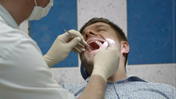 Dentist Having View of Client Teeth alt