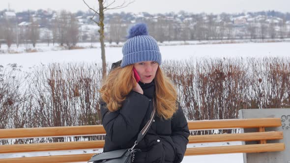 Woman On Bench Talking On The Phone alt