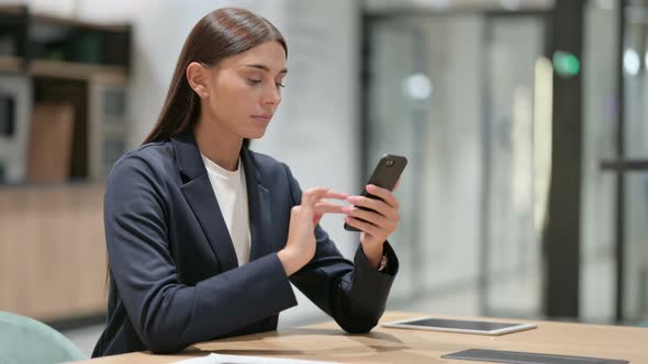 Serious Businesswoman Using Smartphone in Office  alt