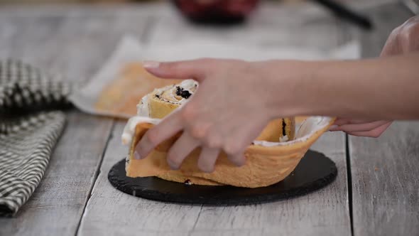 Pastry Chef Making Sponge Cake with Vertical Layers and Blackcurrant Jam alt