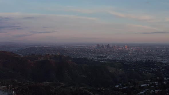 AERIAL: Breathtaking View Over Hollywood Hills with Los Angeles Cityscape in Beautiful Sunset Light  alt