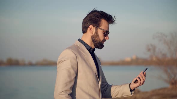 Relaxing Man Staying And Using Mobile Phone For Talking With Colleague. Man Taking Video Call. alt