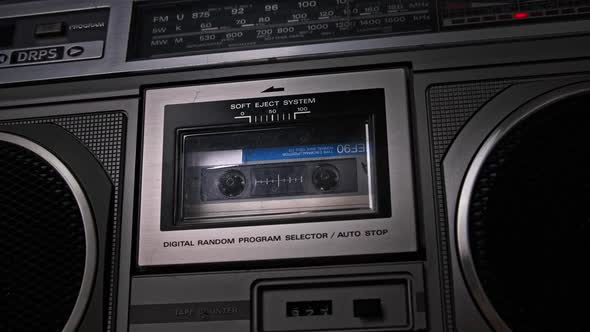Audio Cassette Tape Rotates in Deck of an Old Tape Recorder alt