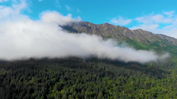 4K Drone Video of Low Elevation Clouds Racing Across Steep Grassy Mountain on Shore of Turnagain Arm alt