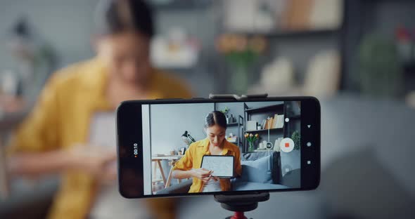 Young Asia lady teacher video call on smartphone talk by webcam learn teach in online chat at home.
