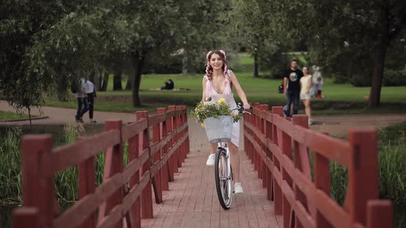 Lovely Woman with Kanekalons Riding a Bicycle.