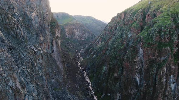 River Winds in Canyon Between Sharp Cliffs with Vegetation alt