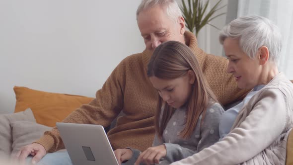 Grandparents and Granddaughter Mastering Laptop alt