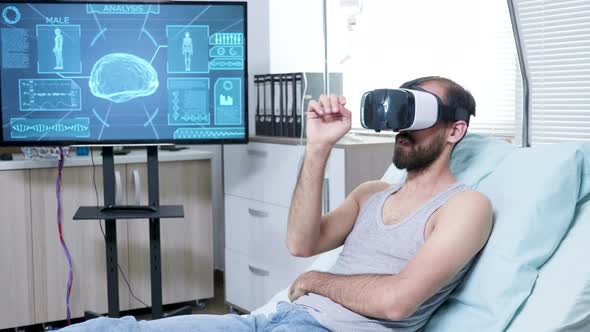 Patient in a Neuroscience Centre Wearing Vr Goggle and Making Hand Gestures alt