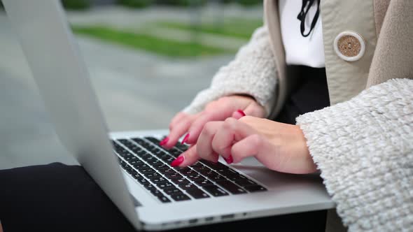 Female fingers pressing a keys on contemporary laptop. Working the computer. alt