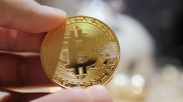 Man Holding in Hand Symbol of Crypto Bitcoin Coin alt