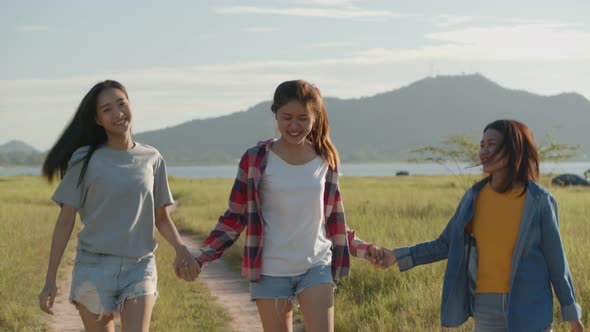 Three young people Asian women running having fun together a summer traveling.