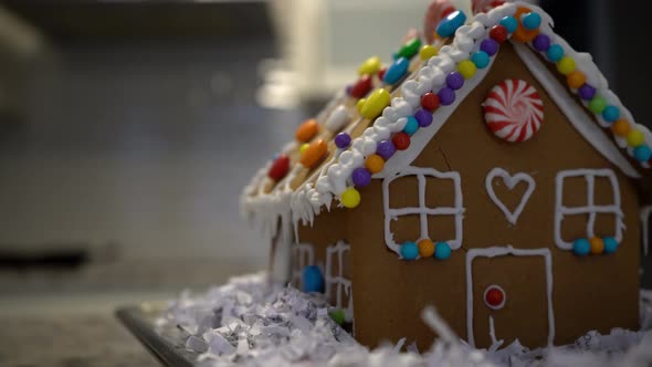Close-up of Decorated Homemade Gingerbread House with Candy and Icing alt