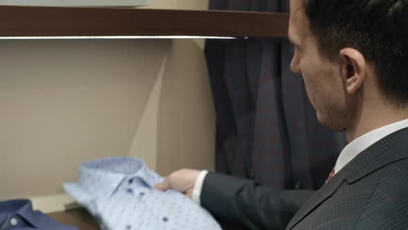 Man Choosing Stylish Shirt alt