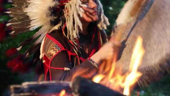 American Indian Shaman Woman Drumming at Night in The Forest 