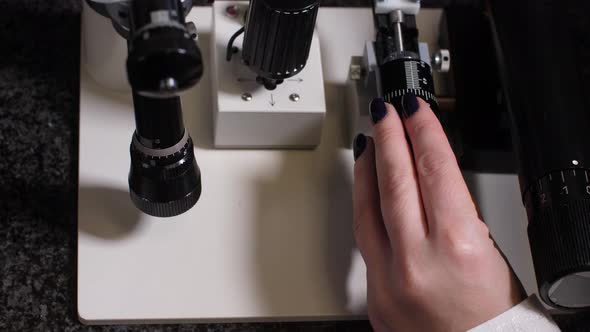 Hand of Embryologist Using Microscope During Work