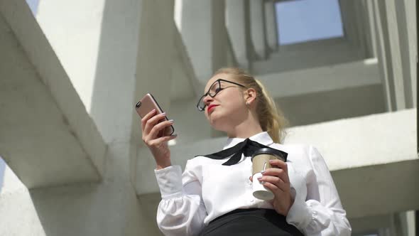 business woman with smartphone and coffee on the street