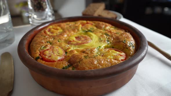 Vegetable frittata with egg, tomato, pepper, onion, cheese and green wild garlic alt