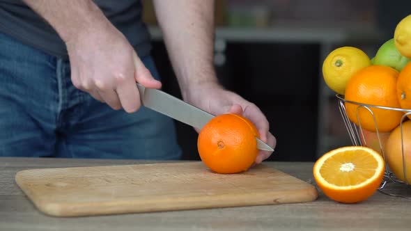 Male Hands are Cutting Ripe Orange for Making Citrus Juice  Healthy Lifestyle Fruit Juice alt