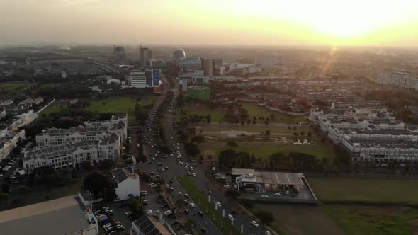 Aerial view of a small city with green areas at sunset