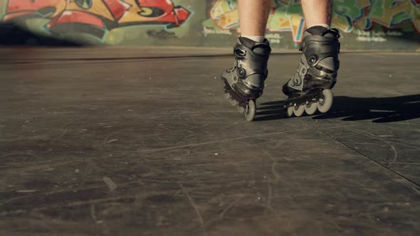 Sporty Man Performing Tricks on Roller Skates at Modern Urban Skate Park alt
