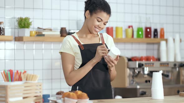 Barista Writing Name of Customer on The Paper Coffee Cup