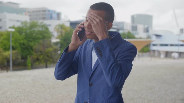 Tired African American Young Man Talking on Smartphone alt