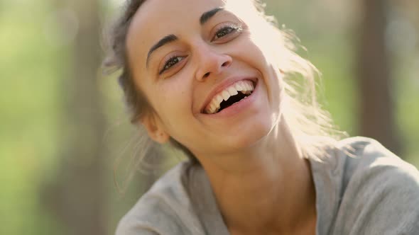 Close Up Happy Young Woman Laughs and Grimaces in Woods alt