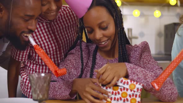 Excited Afircan Woman Receiving Birthday Presents From Friends and Family alt