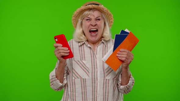 Mature Woman Traveler Tourist Holding Mobile Phone Passport Tickets Waiting for Holiday Vacations alt