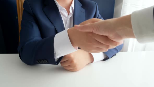 Closeup  Footage of Corrupted Official Shaking Hands with Businesswoman and Receiving Bribe alt