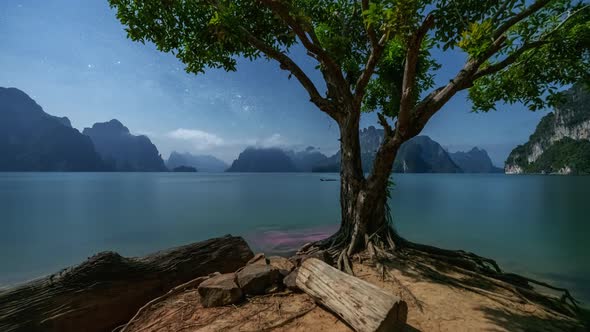 4K Time lapse of milky way and sunrise over Khao sok national park, Surat thani, Thailand alt