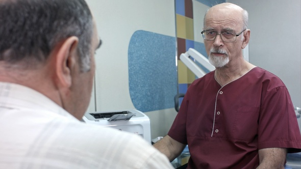 Senior Patient Having Consultation with Doctor in Hospital
