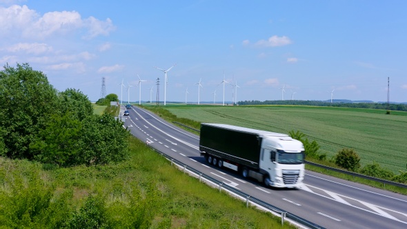 White Truck On Background Of Wind Farm