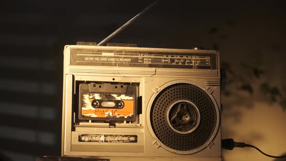 Old Vintage Broken Silver Cassette Player Stands on Table and Plays Audio Cassette with MUSIC alt