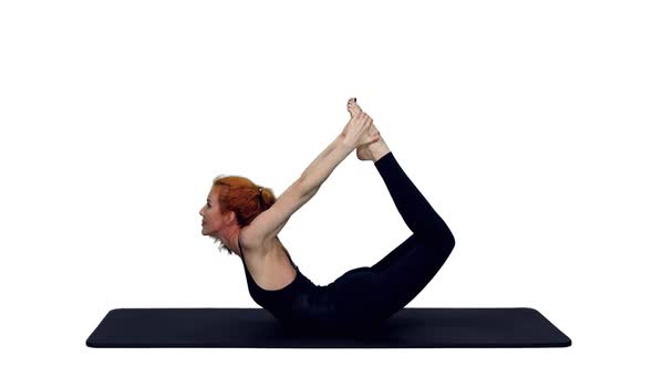 Sporty Slim Woman In Black Bodysuit Doing Yoga on Mat, Alpha Channel Included