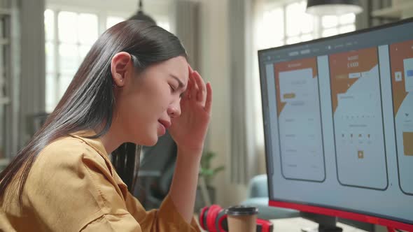 Frustrated Asian Female Mobile Application Developer Works With Graphics On Her Personal Computer alt