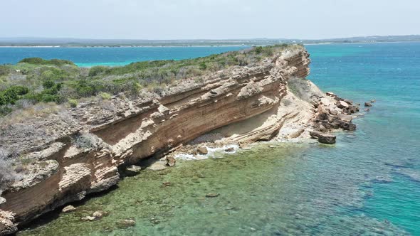 Rugged Cliff With Vegetation In Isla Cabra, Montecristi, Dominican Republic. aerial alt