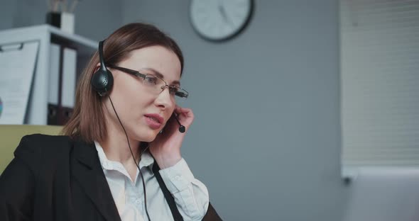 Business Woman Receptionist Wear Headphone Video Conference Calling on Laptop Computer alt