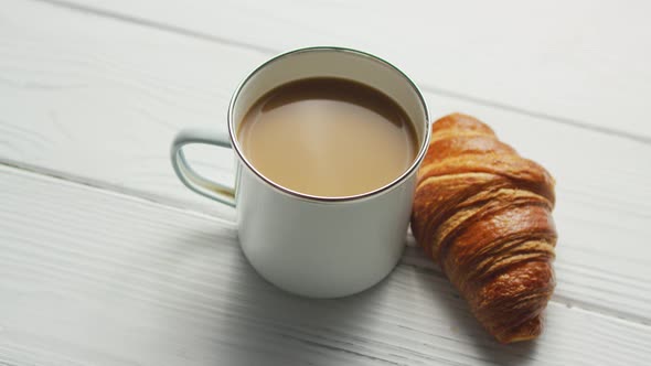 Cup of Coffee and Baked Croissant alt