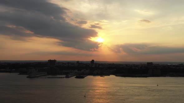 aerial drone shot, pan left showing a golden sunset from Hudson Yards, looking towards New Jersey alt